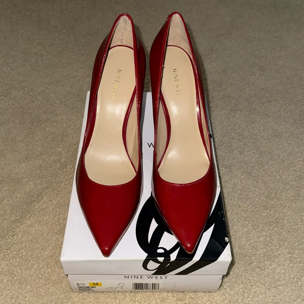Nine West women’s red pointy pumps.